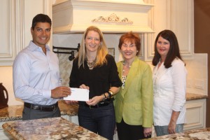 Westin Homes President Jason Golan presents a donation to Rachel Leaman, Charlene Pate, and Debbie Fash